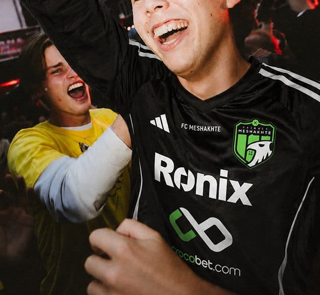 Fans celebrating in Meshakhte jerseys