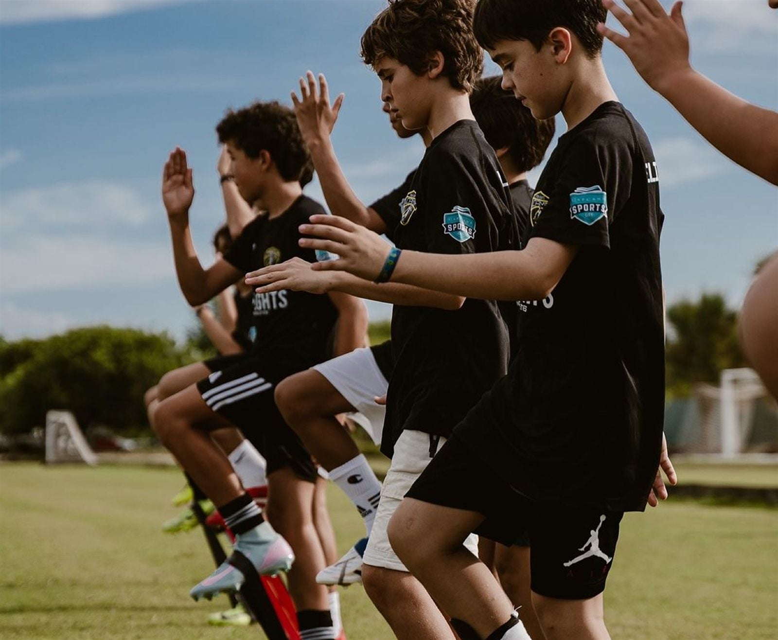Youth players raising their hands during a match