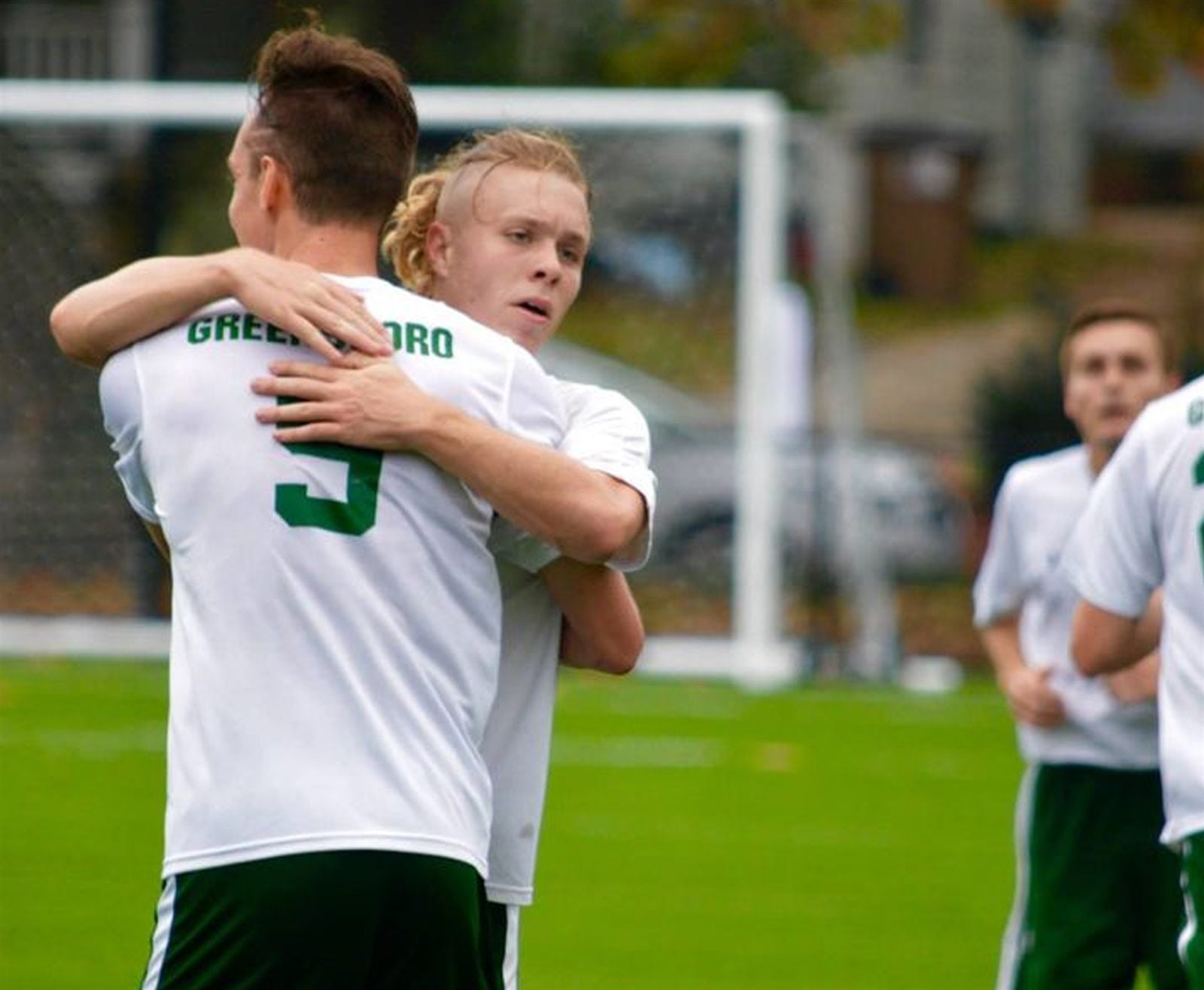 Two players embracing after the final whistle