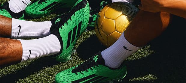 Green boots and a golden ball on the pitch