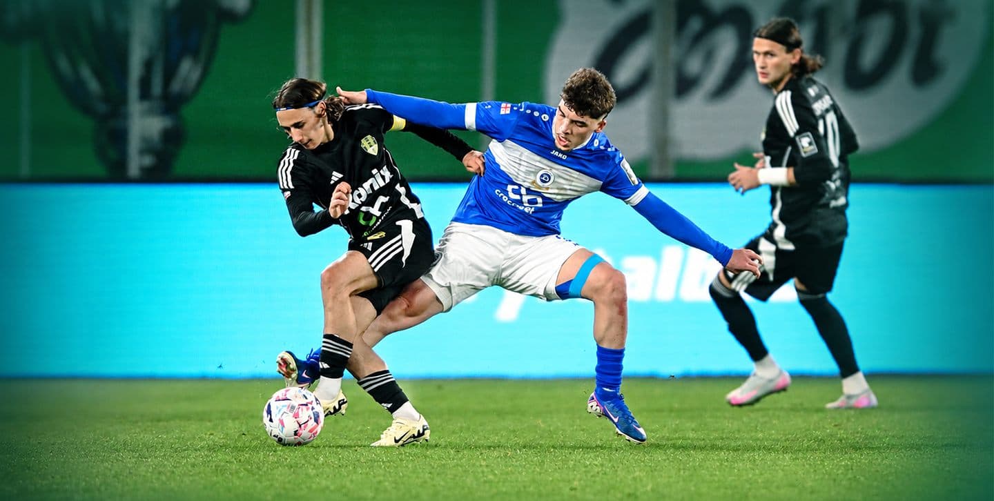 FC Meshakhte player shielding the ball from a Dinamo Batumi defender